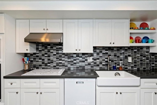 kitchen with dark countertops, white appliances, white cabinetry, and exhaust hood