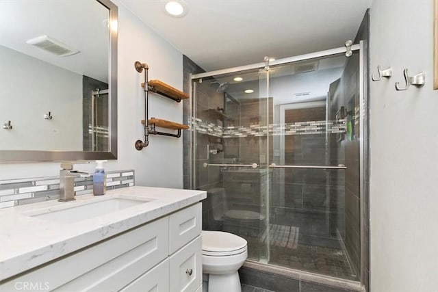 bathroom with vanity, an enclosed shower, and toilet