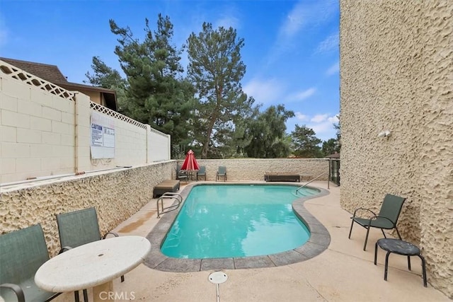 view of swimming pool featuring a fenced in pool, a fenced backyard, and a patio