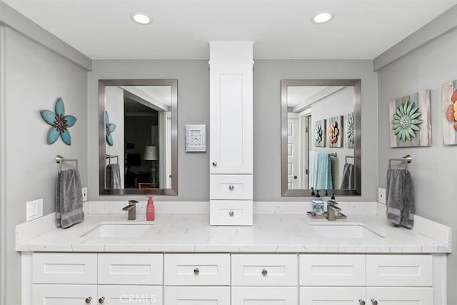 full bathroom with recessed lighting, a sink, and double vanity