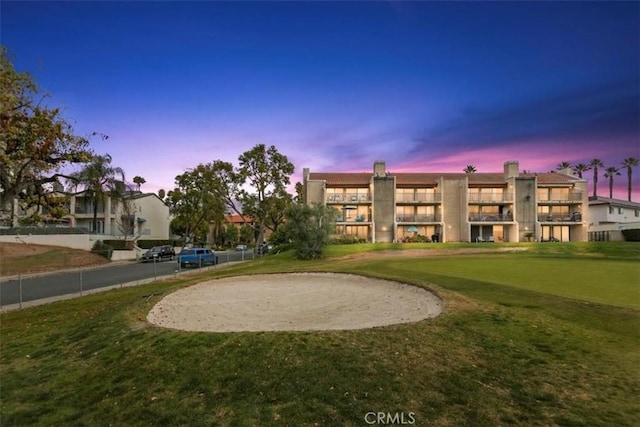 view of property's community with a lawn