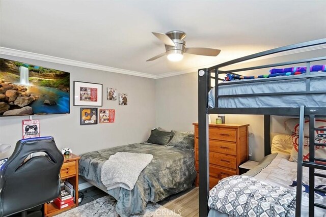 bedroom with crown molding, ceiling fan, and light hardwood / wood-style flooring