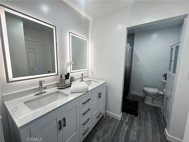 bathroom with vanity, hardwood / wood-style floors, and toilet