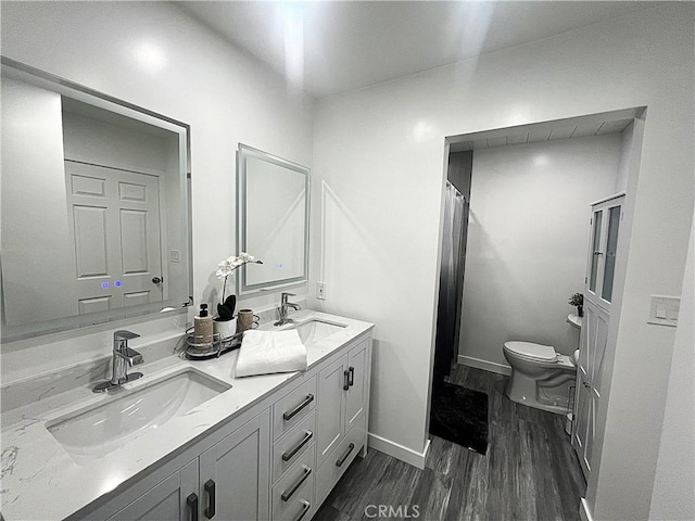 bathroom with a shower with curtain, vanity, toilet, and wood-type flooring