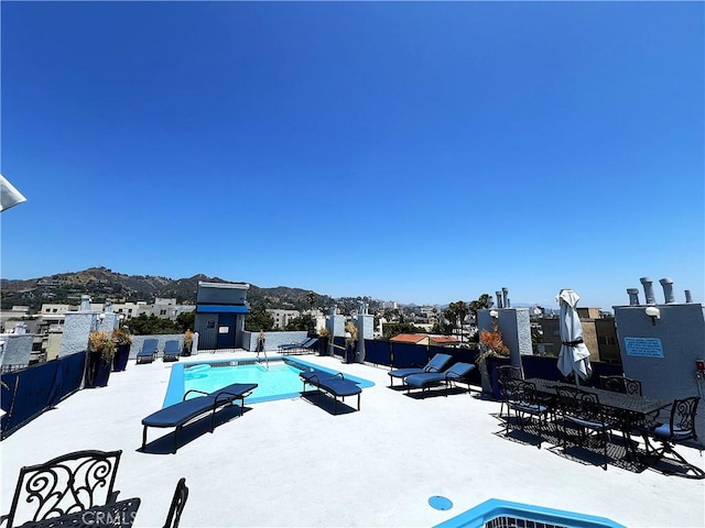 view of pool with a patio and a mountain view