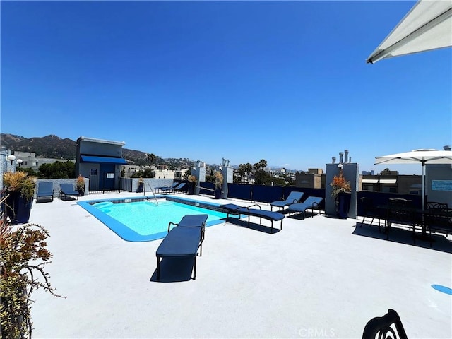 view of pool featuring a mountain view and a patio area