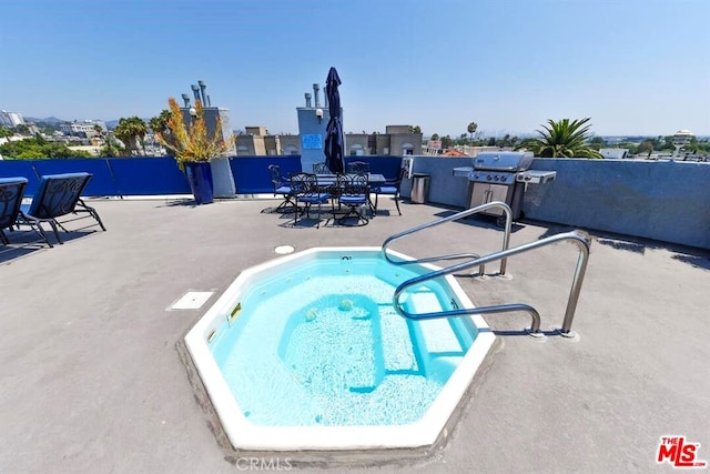 view of pool with area for grilling, a hot tub, and a patio