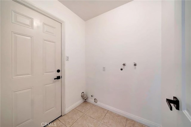 laundry room featuring hookup for a gas dryer and light tile patterned floors