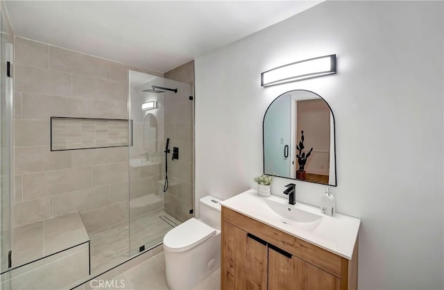 bathroom featuring vanity, an enclosed shower, and toilet