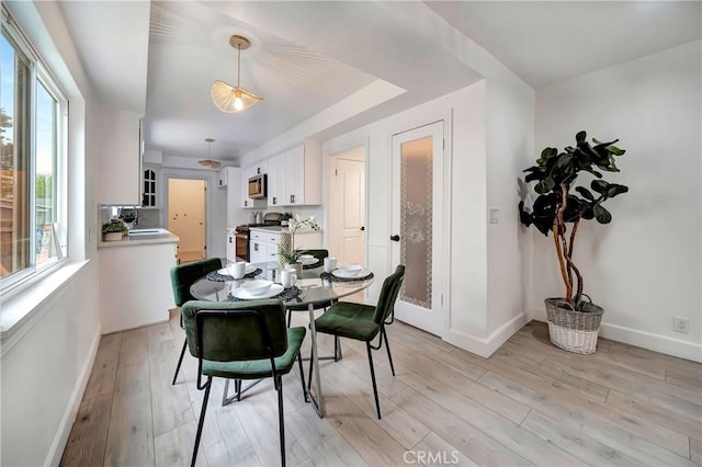 dining room featuring sink and light wood-type flooring