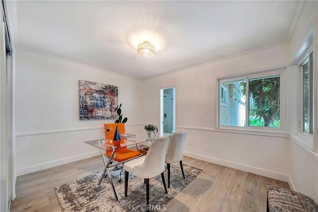 dining room featuring crown molding and light wood-type flooring