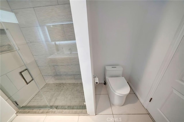 bathroom with an enclosed shower, tile patterned floors, and toilet