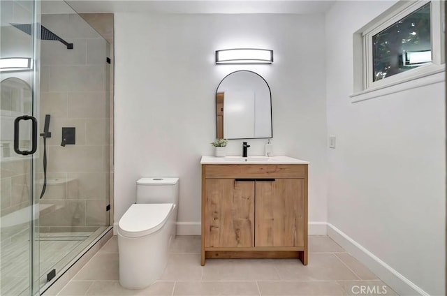 bathroom featuring tile patterned flooring, vanity, a shower with door, and toilet