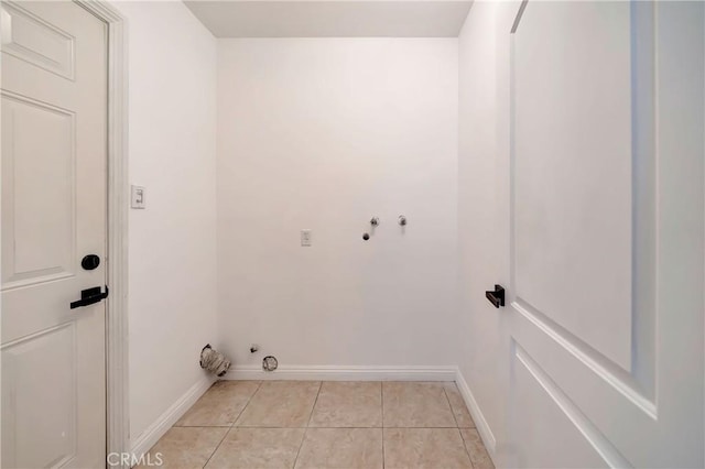 clothes washing area with gas dryer hookup, light tile patterned floors, and hookup for a washing machine