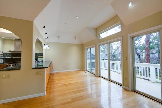 unfurnished living room with lofted ceiling and light hardwood / wood-style flooring