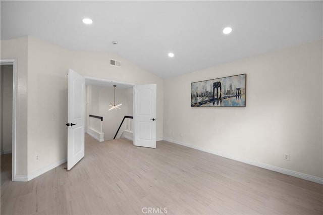 unfurnished bedroom with recessed lighting, visible vents, baseboards, vaulted ceiling, and light wood-style floors