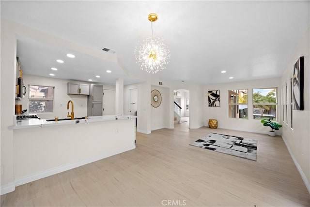 interior space featuring arched walkways, recessed lighting, visible vents, and light wood-style floors