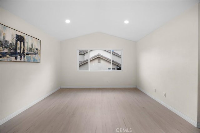 spare room with light wood-style floors, recessed lighting, vaulted ceiling, and baseboards