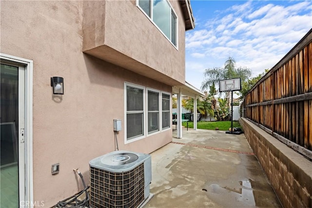 view of patio / terrace featuring fence and central AC unit