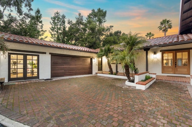 view of front facade with french doors and a garage