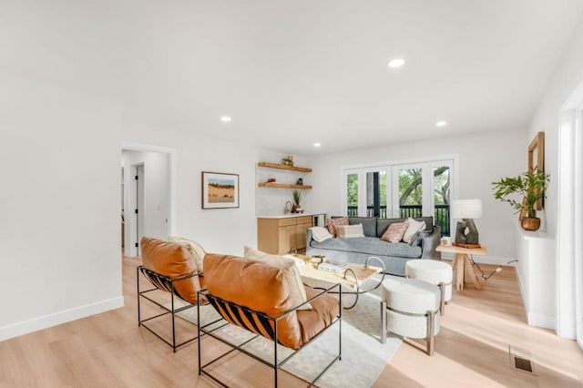 living room with light hardwood / wood-style floors and french doors