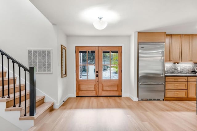 interior space with light wood-type flooring and french doors