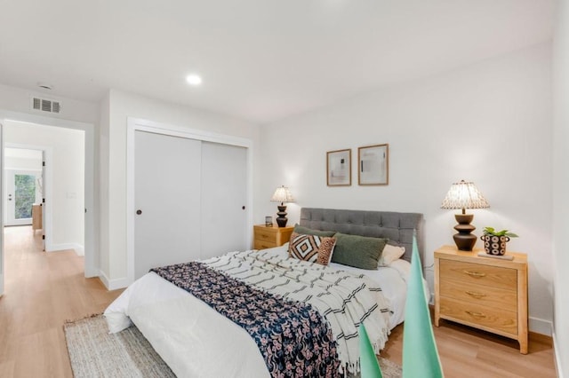 bedroom featuring hardwood / wood-style floors and a closet