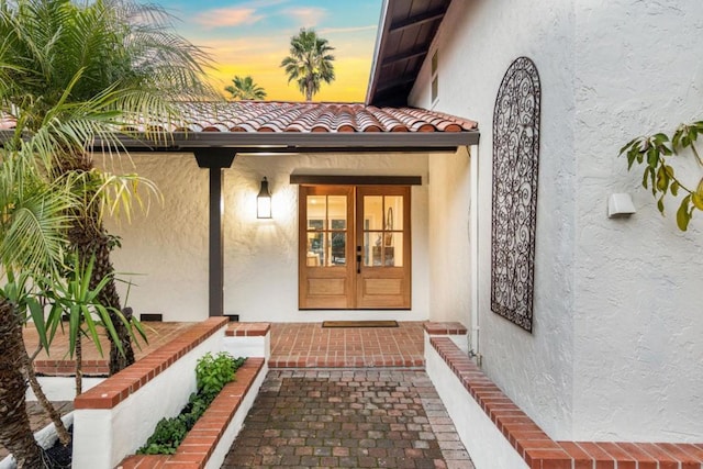 exterior entry at dusk with french doors