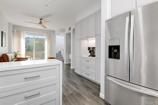 kitchen featuring white cabinets, stainless steel fridge, ceiling fan, and light hardwood / wood-style flooring