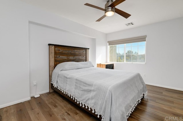 bedroom with dark wood-type flooring and ceiling fan