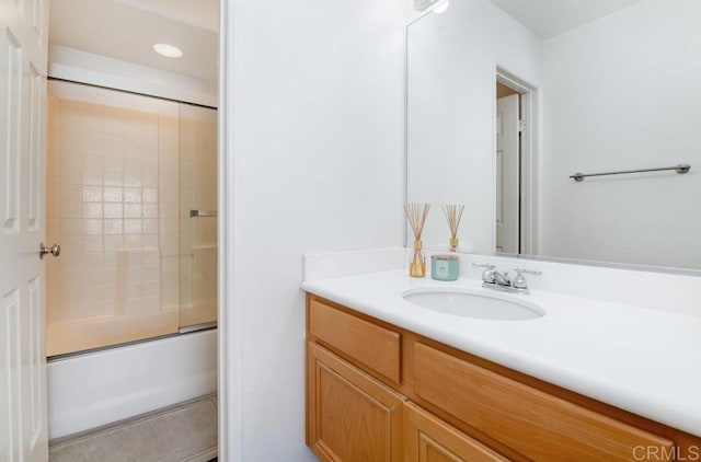 bathroom featuring vanity and bath / shower combo with glass door