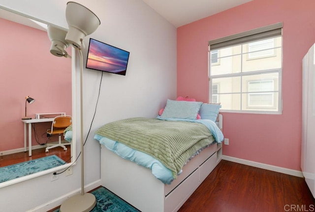 bedroom with dark hardwood / wood-style floors