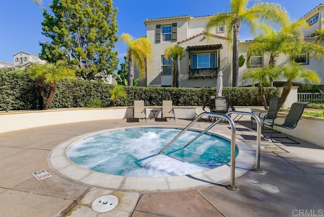 view of swimming pool with a community hot tub and a patio