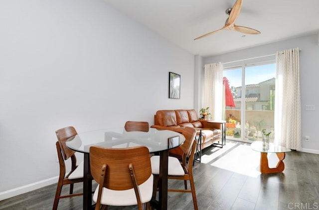 dining space with dark wood-type flooring and ceiling fan