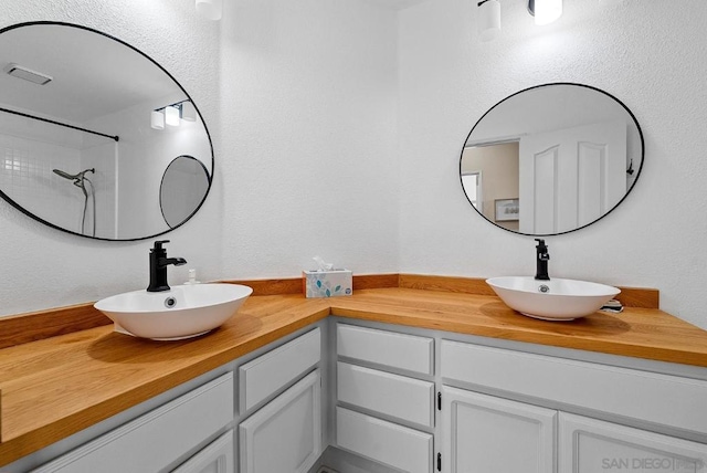 bathroom with vanity and walk in shower