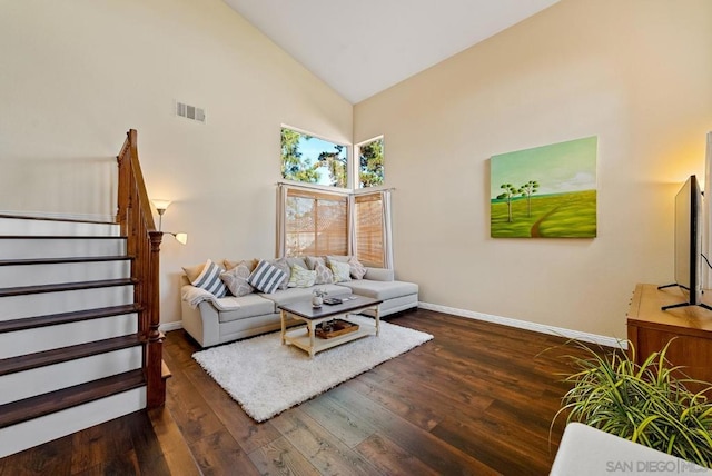 living room with dark hardwood / wood-style flooring and high vaulted ceiling