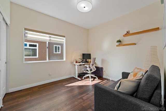 home office with dark hardwood / wood-style floors