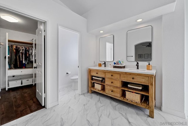 bathroom featuring vanity and toilet