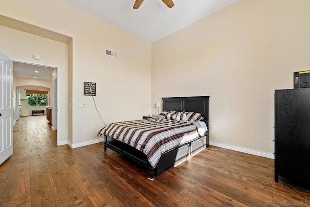 bedroom with ceiling fan and dark hardwood / wood-style floors