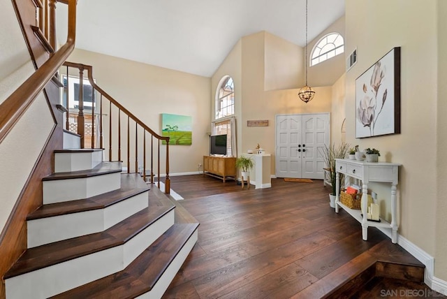 foyer featuring dark hardwood / wood-style floors and high vaulted ceiling