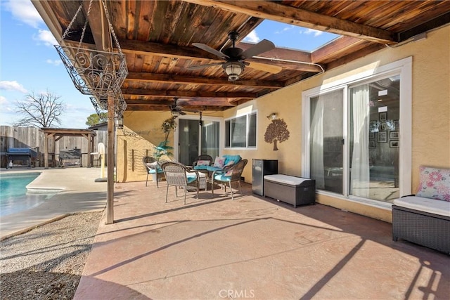 view of patio with an outdoor living space, a fenced in pool, and ceiling fan