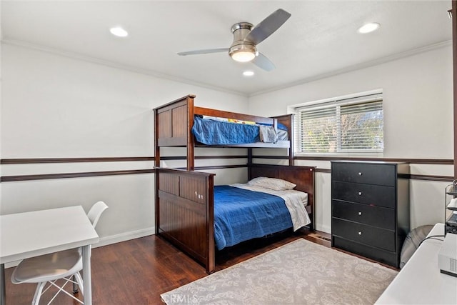 bedroom with dark hardwood / wood-style flooring, crown molding, and ceiling fan