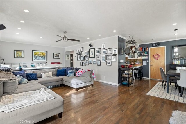 living room featuring dark hardwood / wood-style flooring, ornamental molding, and ceiling fan