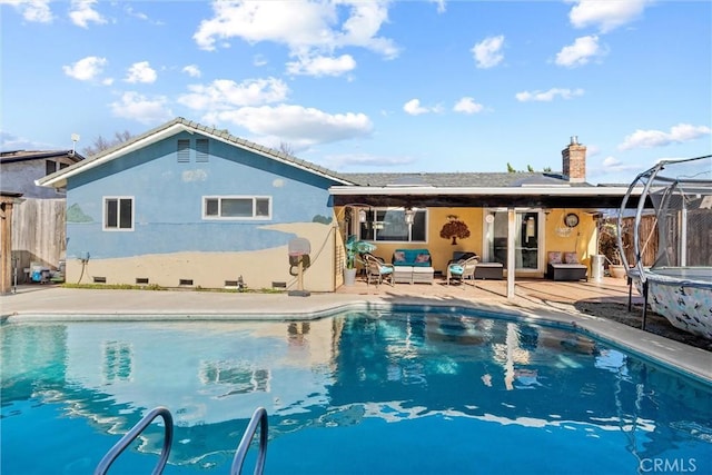 view of pool with a fenced in pool, a trampoline, outdoor lounge area, and a patio area