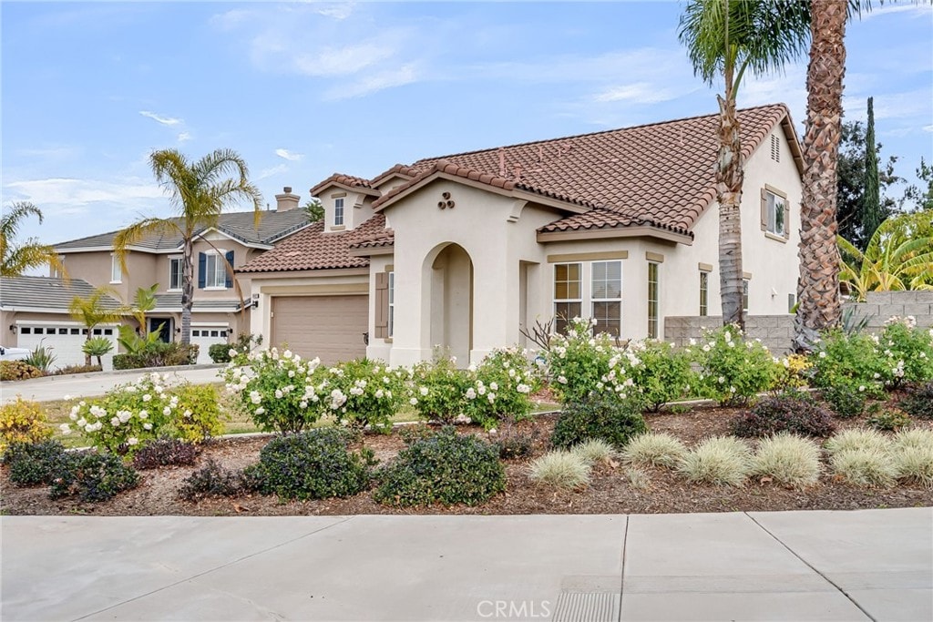 mediterranean / spanish-style house featuring a garage