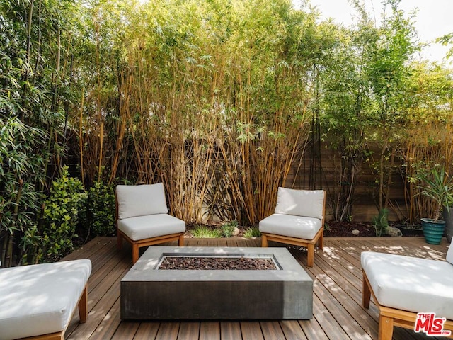 wooden terrace with an outdoor fire pit