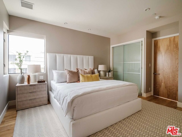 bedroom with a closet and light wood-type flooring