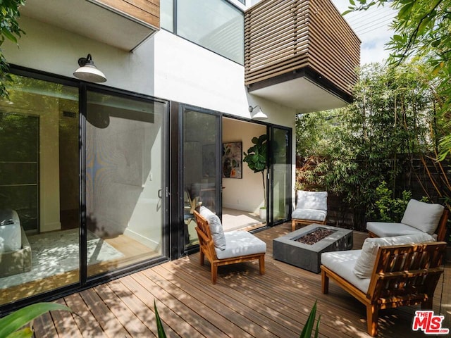 deck featuring an outdoor fire pit