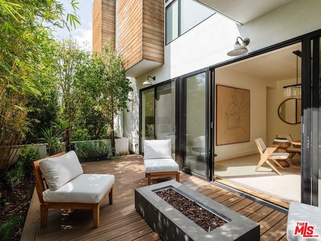 wooden deck with a fire pit