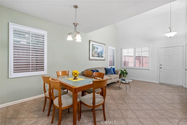 tiled dining room with vaulted ceiling and an inviting chandelier